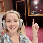 Kelly Stables (voice of Olivia) points out her good friend Natalie Lander (voice of Zoe) in a booth in the recording studio