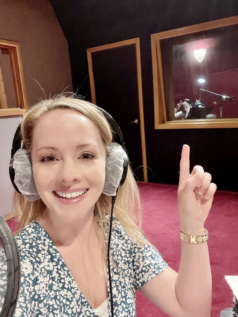 Kelly Stables (voice of Olivia) points out her good friend Natalie Lander (voice of Zoe) in a booth in the recording studio